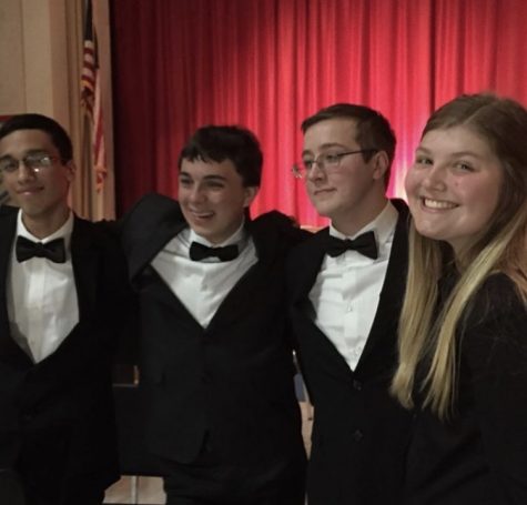 Haley poses with the Barbershop Quartet after a choir concert
