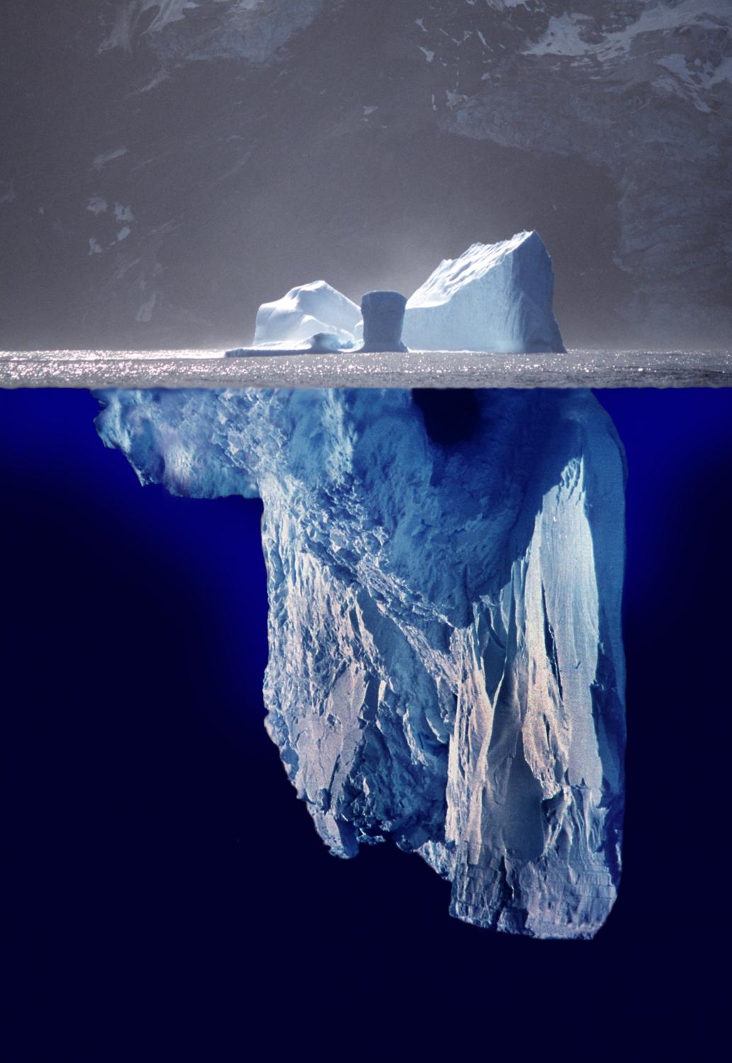 The tip of an iceberg is a small, unrepresentative portion of something much larger or deeper that can't be seen or understood.
