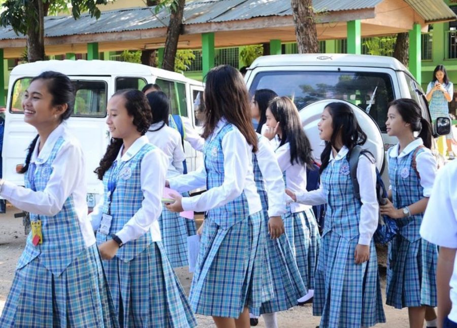 Students from Gusa Regional Science High School in their white and light blue uniforms.