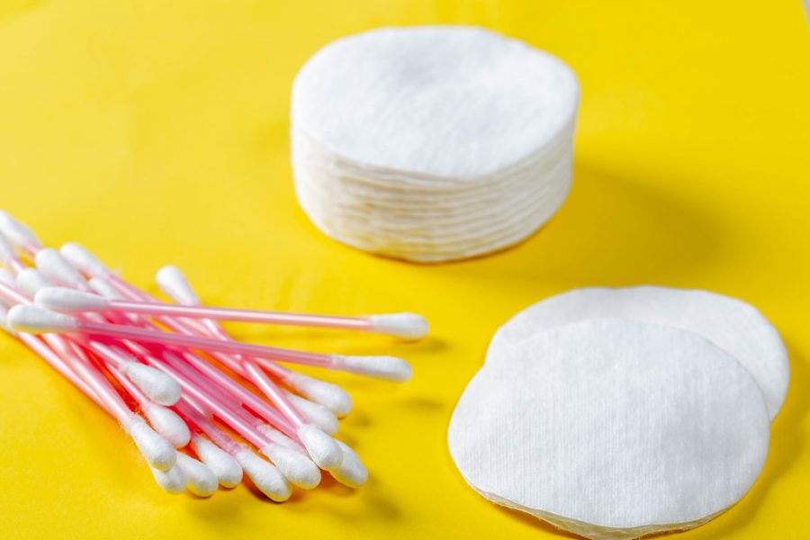 Cotton swabs and cotton rounds for face care on a yellow background by wuestenigel is licensed under CC BY 2.0