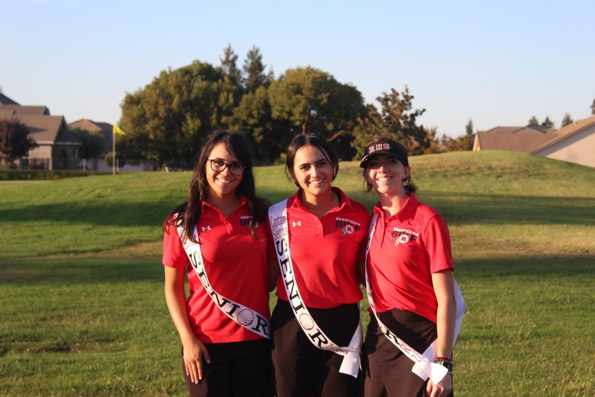 Seniors Dylan Ballard, Sienna Pimentel, and Skylar Pimentel after their match.