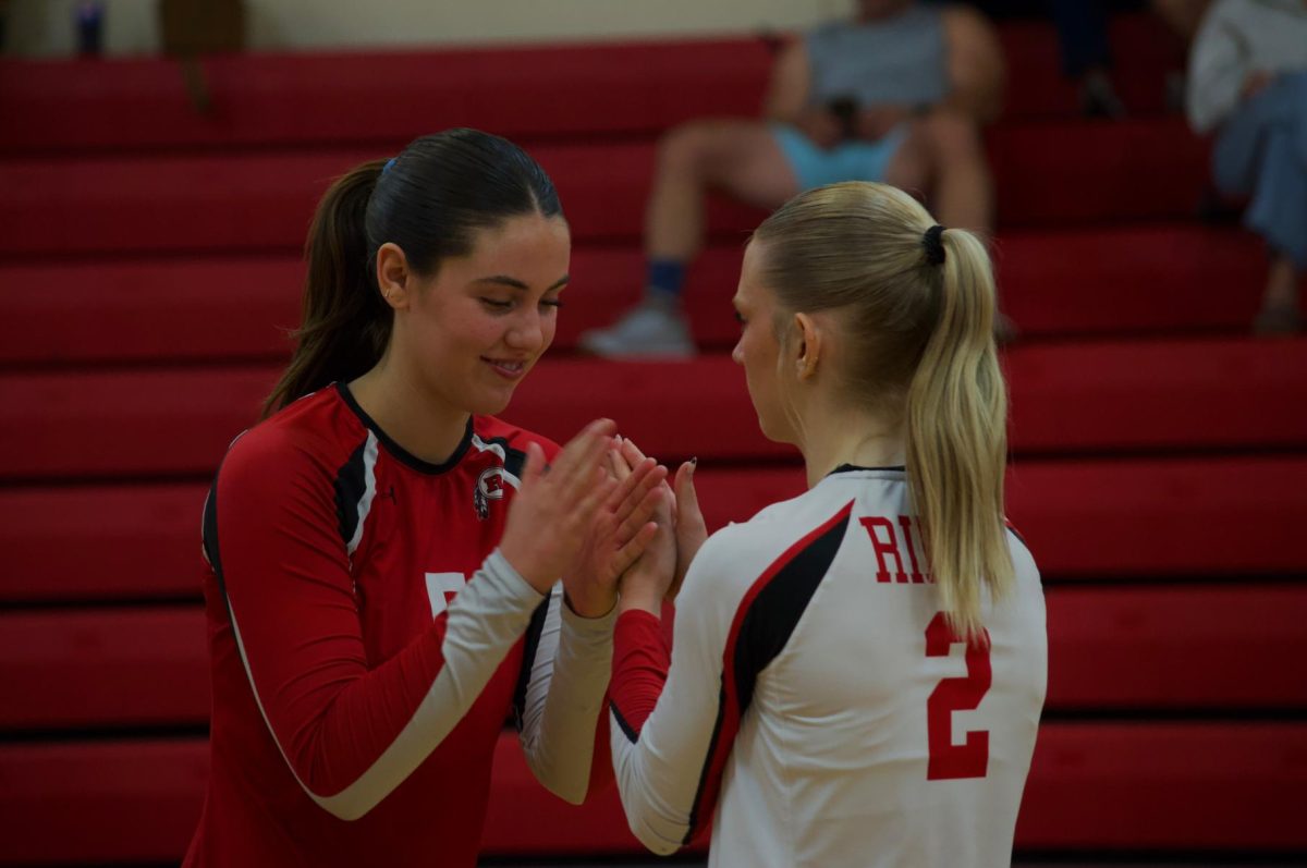 Adriana Dorn (Left) and Kennedy Everhart (Right) doing their pregame ritual